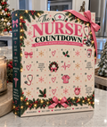 The Nurse Countdown advent calendar, a cream and pink box with 24 numbered doors, a pink ribbon bow, pine garland and fairy lights