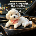 White bichon squishy silicone puppy lying with a red checkered bandana on a black silicone mat in a car